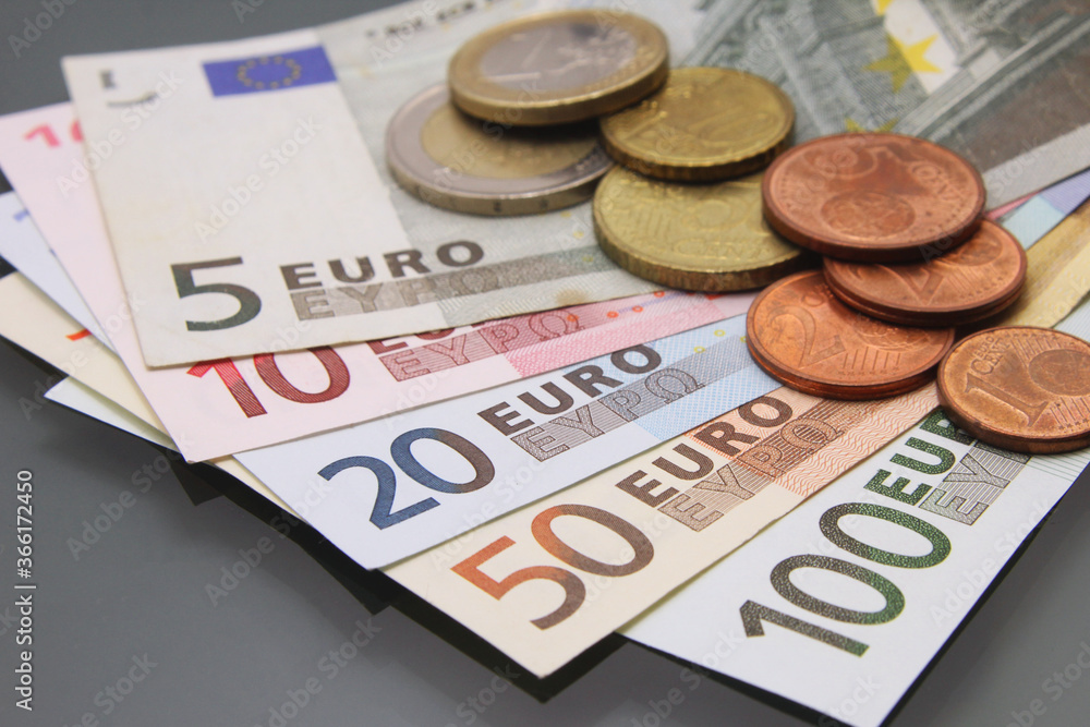 Euro currency money, euro money banknotes, various bills and coins, close-up on dark background. Cash money Euro currency money, euro money banknotes, various bills and coins, close-up on dark background. Cash money