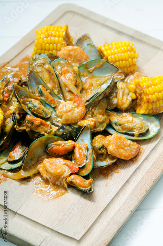 fresh seafood, clam and shrimp with fresh corn on the grill