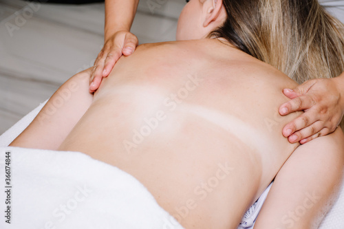woman getting a shoulder massage by a massager