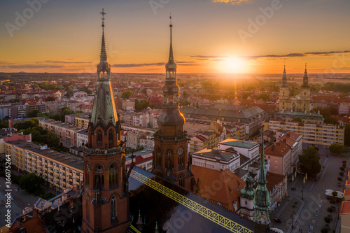 Aerial drone view of the Cathedral of St. Peter and Paul the Apostles and old town buildings before sunset. The sun's rays beautifully highlight the urban architecture in Legnica, Poland © Piotr Mitelski