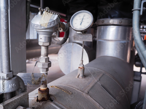 Temperature transmitter for measuring instrument close up in industry zone at power plant.