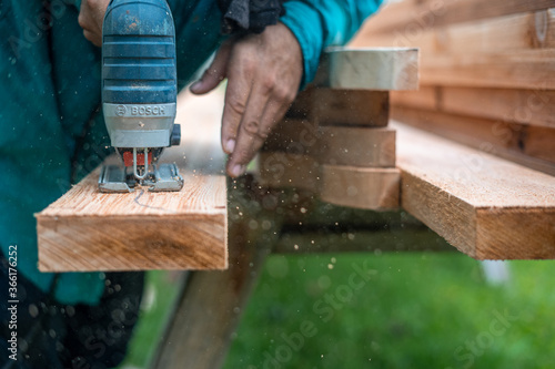Carpenter sawing wood 