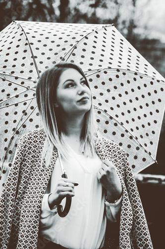Woman thinking while holding an umbrella, black and white picture, black and white picture