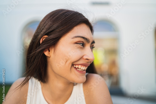 Close-up of young latin woman smiling.