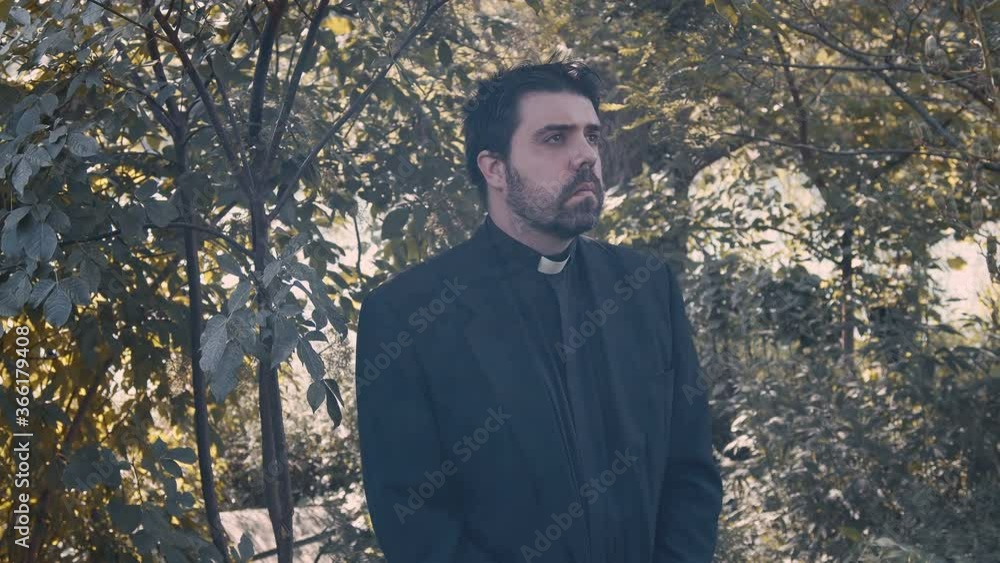 priest standing outside in nature priest standing outside in nature