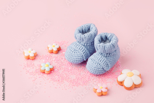 Baby shoes, booties on pink background, first newborn party background, birthday, expectation of newborn, motherhood, maternity, parenthood, minimal monochrome card, banner, copy space