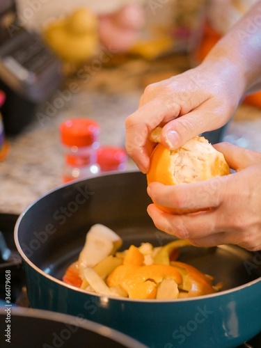 chef preparing food in the kitchen by peeling oranges