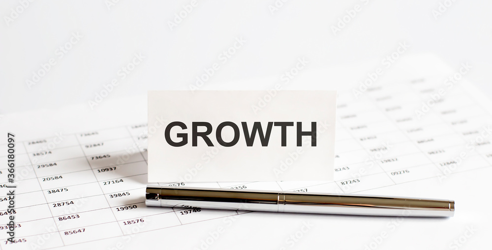 Text GROWTH on stickers,pen on the background of documents. Financial bookkeeping, Accounting Concept. Top view. Text GROWTH on stickers,pen on the background of documents. Financial bookkeeping, Accounting Concept. Top view.