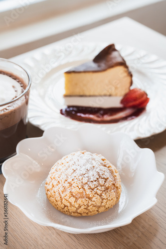 Choux cream, basque cheesecake and hot chocolate on a table