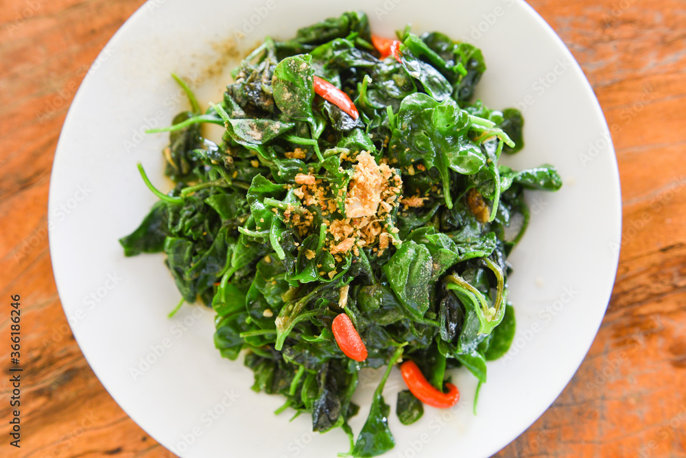 Stir fried oyster sauce watercress vegetable on white plate Health food green vegetables cooked food in thailand Stir fried oyster sauce watercress vegetable on white plate Health food green vegetables cooked food in thailand