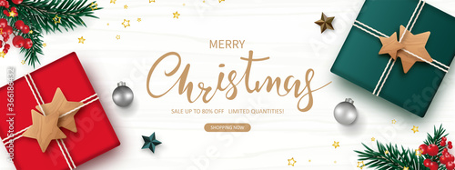 Christmas sale. Xmas banner decorated with  Gift box, Christmas ball, red berry, green pine, star, isolated on white wooden background. Flat lay. Vector illustration.