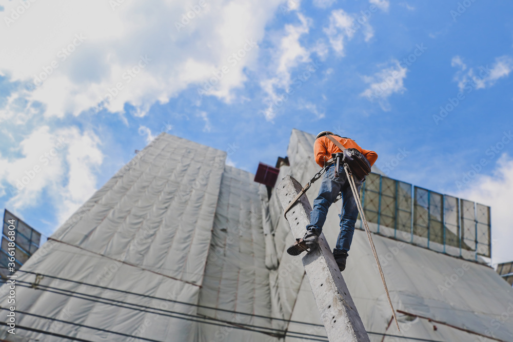 custom made wallpaper toronto digitalElectrician climb working in the height with safety belt on building construction background.