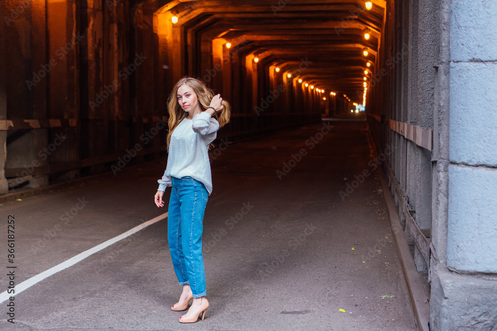 Young girl standing in a tunnel with lights Young girl standing in a tunnel with lights
