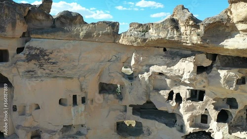 Aerial view of Cavusin-Cappadocia A lot of stone houses and churchs. ancient village Cavusin. turkey tourism trip. aerial shooting drone. in Nevsehir Turkey fairy chimneys zoom out shooting