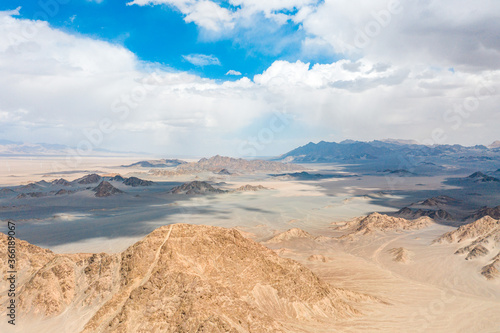aerial view of sand moutain in desert with blue sky