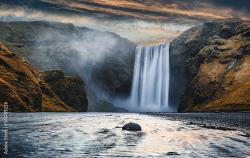 Majestic nature of Iceland. Impressively View on Skogafoss Waterfall with colorful sky glowing sunlight, during sunrise. Skogafoss the most famous place of Iceland. creative artistic image. postcard