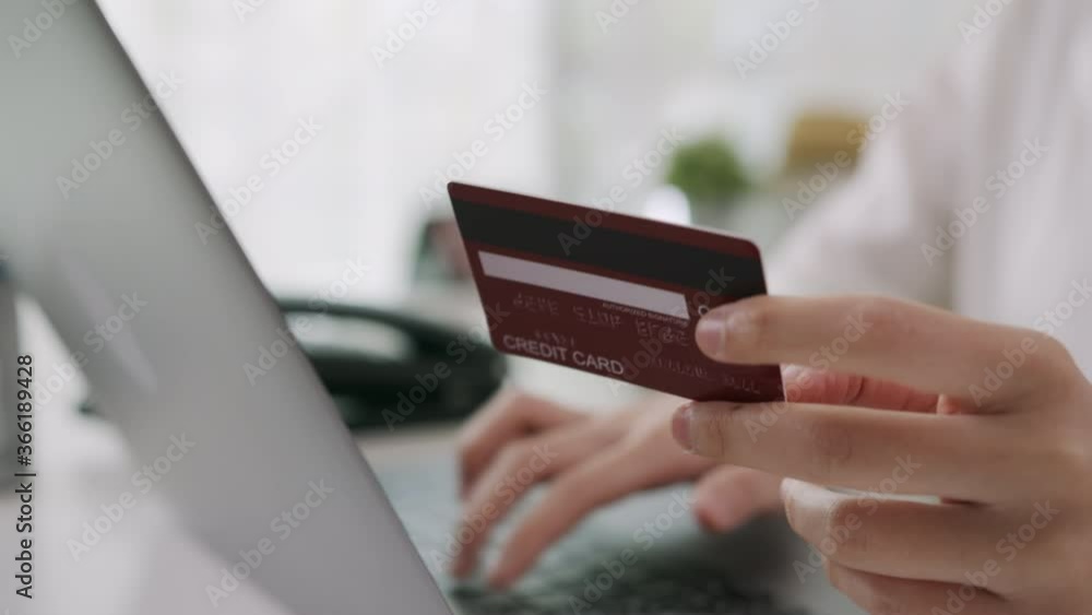 woman in casual clothes holding credit card and using digital laptop with shopping online woman in casual clothes holding credit card and using digital laptop with shopping online