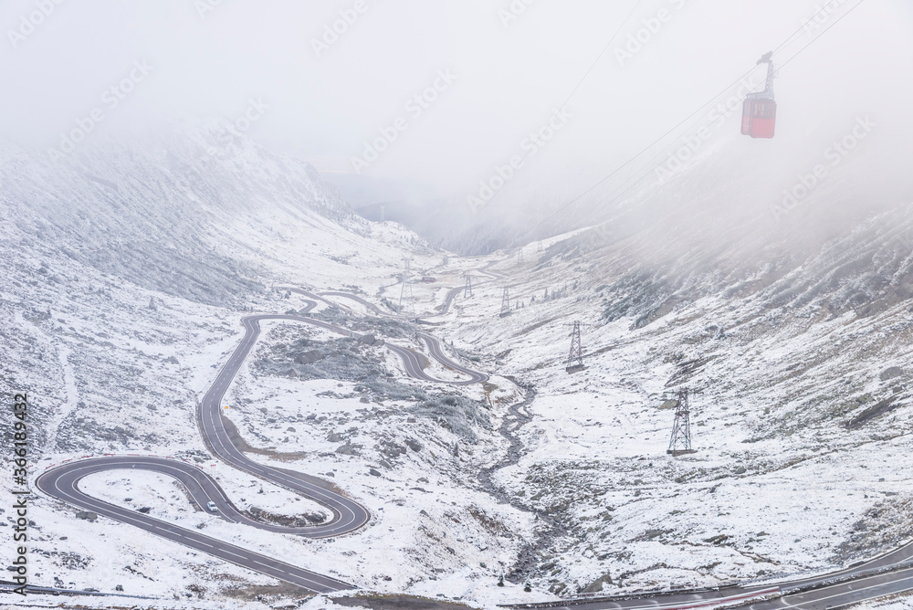 A high altitude view of the winding road heading to Balea Lake