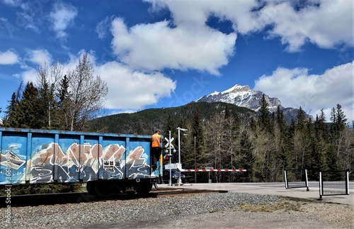 train in the mountains with man onside photo