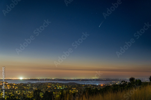 Comet NEOWISE in the early night sky over Folsom Lake in Folsom California. 