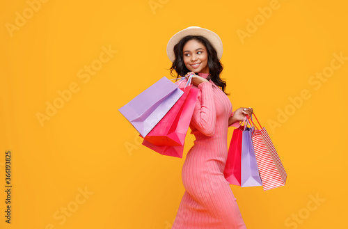 Happy ethnic shopper with paper bags. photo