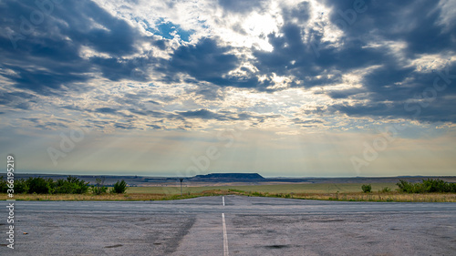 Intersection on the road. The sun s rays break through the clouds