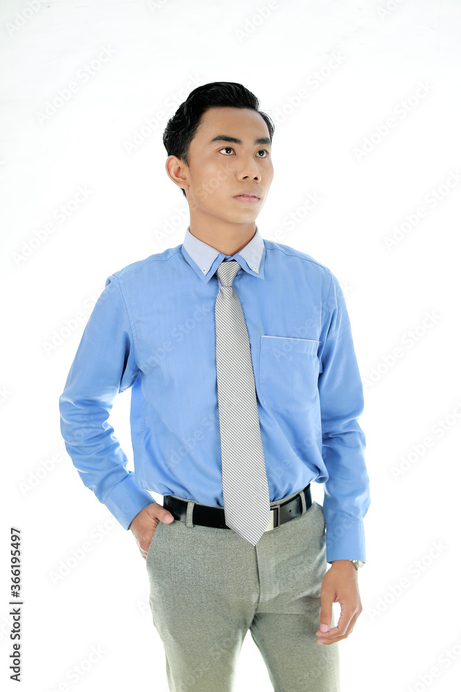 Confidence and business concept. Portrait of charming successful young entrepreneur in blue-collar shirt, smiling broadly with self-assured expression isolated White Background. Indonesian People Confidence and business concept. Portrait of charming successful young entrepreneur in blue-collar shirt, smiling broadly with self-assured expression isolated White Background. Indonesian People