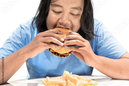 Asian man eating a hamburger