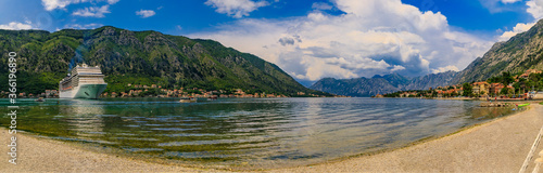 Panorama of Kotor Bay with a cruise ship and mountains reflecting in the water, Balkans on Adriatic Sea in Kotor, Montenegro