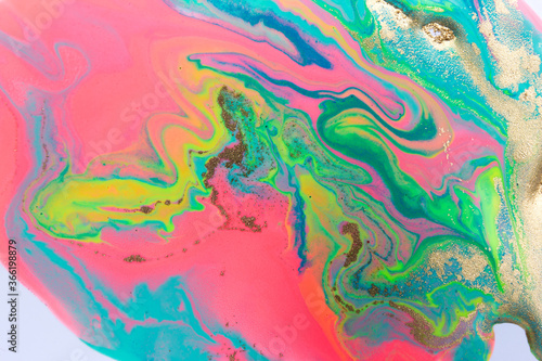 Liquid abstract pattern. Mixed pink paint with green, blue and gold waves.