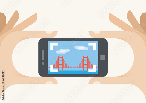 Tourist mobile phone camera taking Golden Gate bridge photo, San Francisco, California. Concepts: photography sharing services (Instagram), tourism, holiday, travel, famous places, vacation, blogging