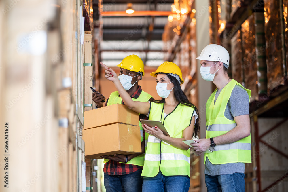 Group of diversity Workers wearing protective mask working in factory Group of diversity Workers wearing protective mask working in factory