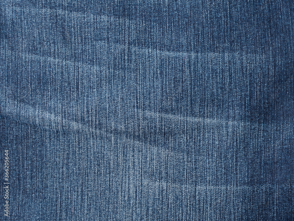 Worn jeans fabric plain surface background, blue denim textile texture Worn jeans fabric plain surface background, blue denim textile texture