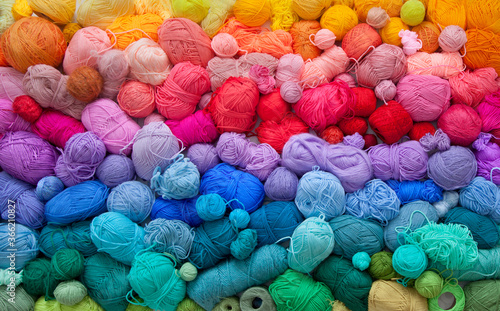 Colored balls and skiens of yarn for knitting. Top view. Rainbow colors. Color horizontal gradient.