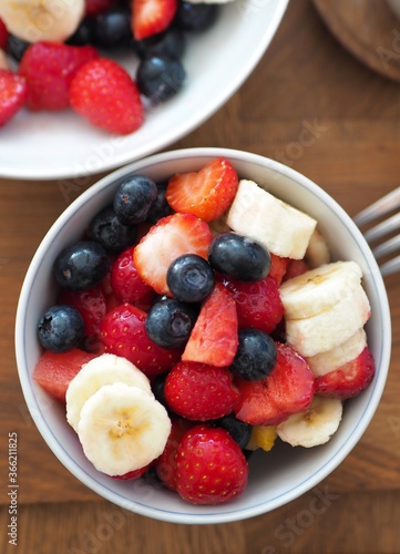 OLYMPUS DIGITAL CAMERA Fruit salad in bowl with blueberries  strawberries and banana.