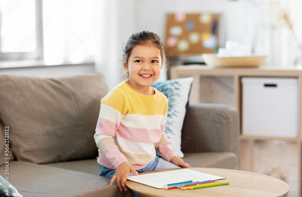 childhood, creativity and art concept - happy smiling little girl drawing with coloring pencils at home childhood, creativity and art concept - happy smiling little girl drawing with coloring pencils at home