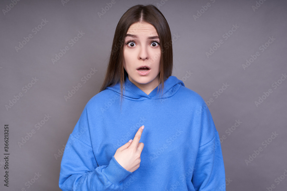 Dissatisfied, surprised woman points at herself indignantly. Dissatisfied, surprised woman points at herself indignantly.