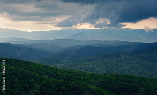 Rain over forest mountains. Misty mountain landscape hills at rainy day.