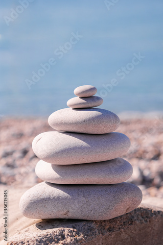 Symbol Scales is made of stones of various shapes. Balance of stones. Balancing stones on the shore. Tourism  travel.
