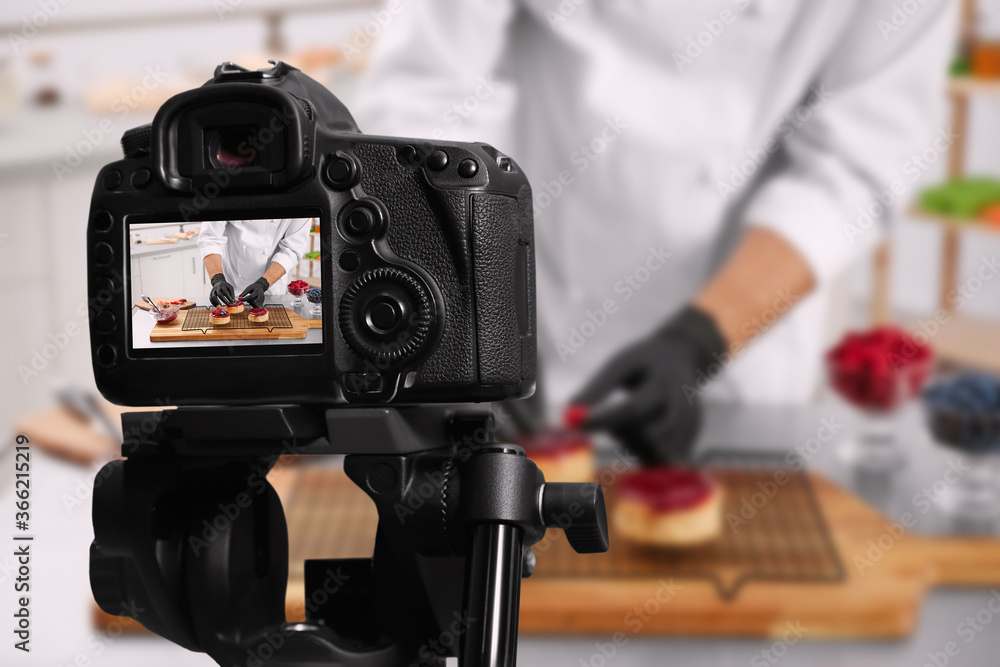 Food photography. Shooting of chef decorating dessert, focus on camera