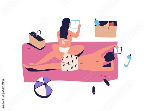 Sunbathing couple, woman and man on vacation picnic, reading book. Girlfriend...