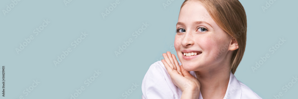 Beauty girl portrait. Young woman. Hand near nead. Face massage concept. White shirt. Cosmetology facelift laser. Medical rejuvenation scrub. Skin care hygiene. Grey background. Smiling Beauty girl portrait. Young woman. Hand near nead. Face massage concept. White shirt. Cosmetology facelift laser. Medical rejuvenation scrub. Skin care hygiene. Grey background. Smiling