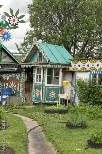 Old wooden traditional national rural Lobanov's house with carved windows, frames in Leshkovo village, Sergiyev Posad district, Moscow region, Russia. Russian folk style in wooden architecture. Summer photo