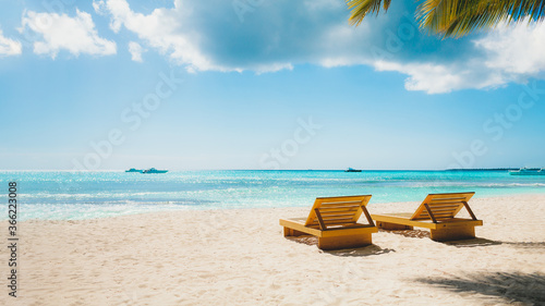 Vacation summer holidays background - sunny tropical Caribbean blue lagoon paradise beach with white sand palms, and loungers © Vasily Makarov