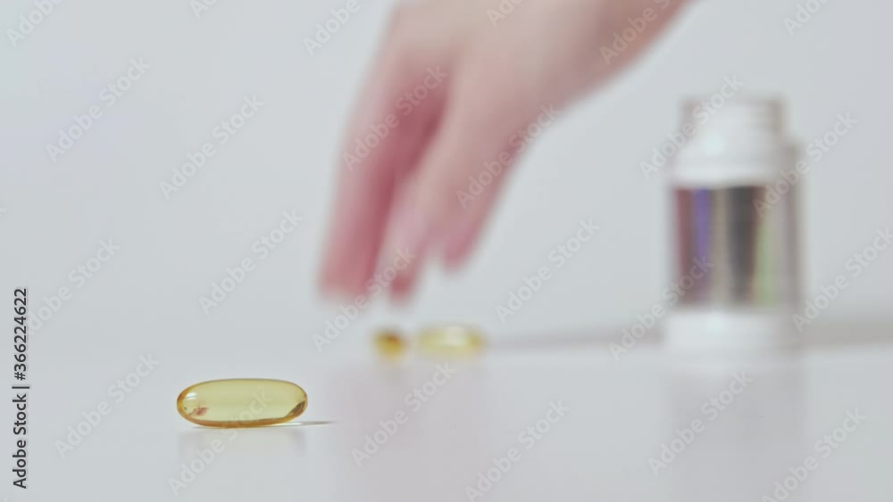 Dietary supplement. Pharmaceutical drug. Hand collecting capsules on white blur background set of 2. Dietary supplement. Pharmaceutical drug. Hand collecting capsules on white blur background set of 2.