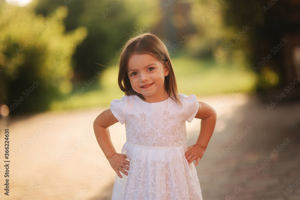 Portrait of happy smiled little girl in white dress Portrait of happy smiled little girl in white dress