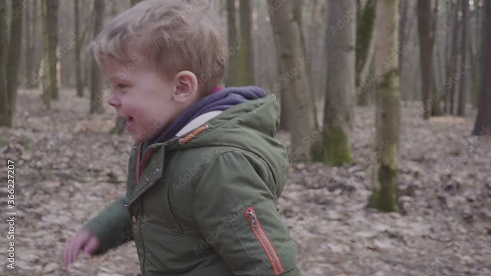 Small boy running in the forest, laughing and playing hd Small boy running in the forest, laughing and playing hd