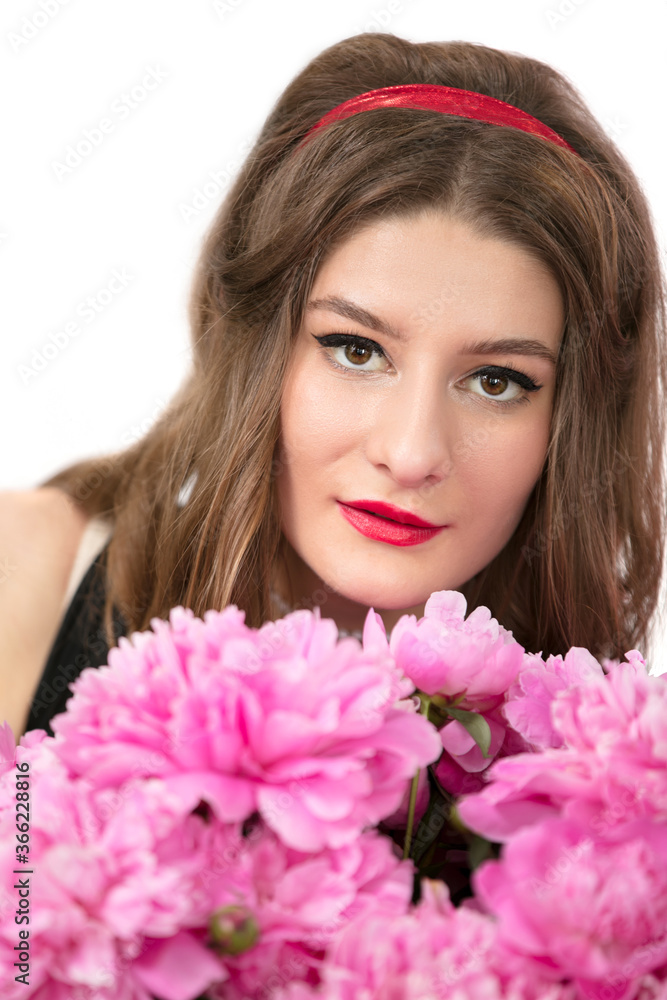 Portrait of a beautiful girl with pink flowers. Woman portrait in the style of the seventies. Portrait of a beautiful girl with pink flowers. Woman portrait in the style of the seventies.