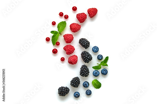 Blueberry, raspberry, blackberry, redcurrant isolated on white. Fresh blueberry, berries mix closeup. Red raspberry, blue blackberry, mint creative composition. Colorful trendy concept, top view.