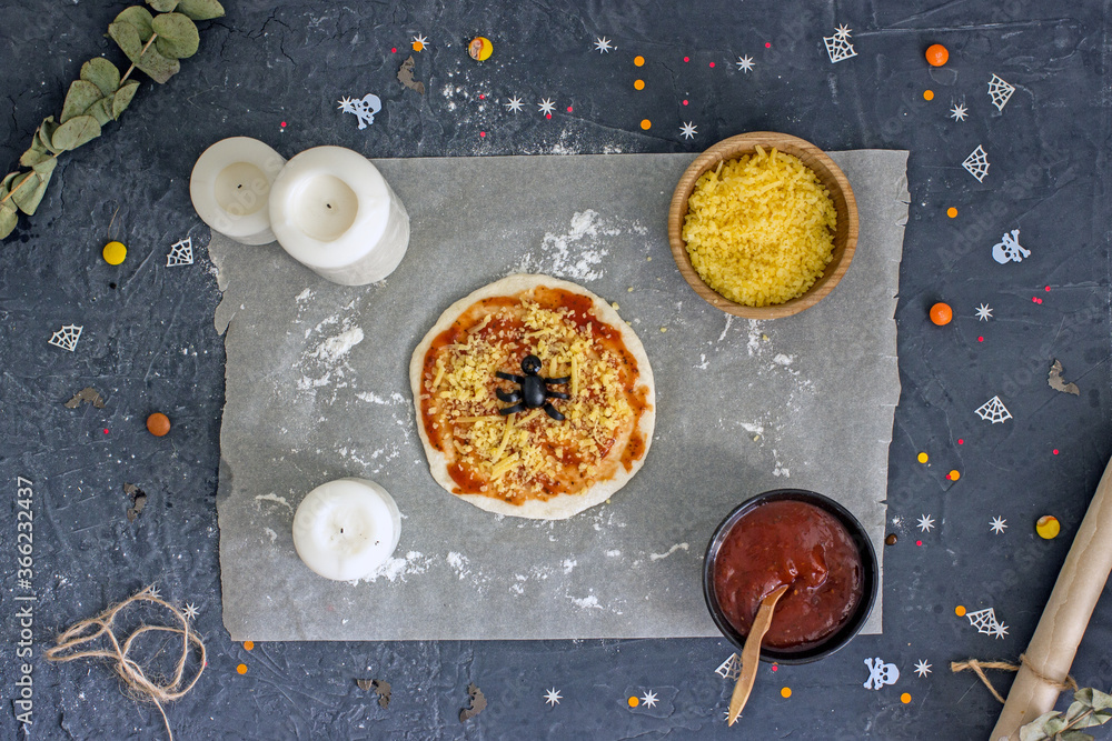 Halloween pizza with olive spiders, cheese and tomato. Step-by-step instructions for making pizza, step 6. Making a spider from olives